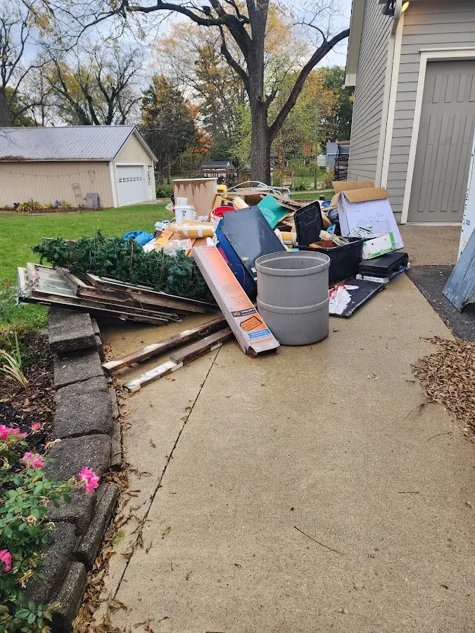 Dumpster being loaded with debris for Estate Cleanout Dumpster Rental in Verdigris